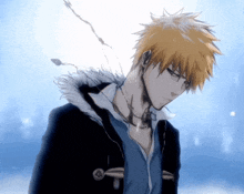 a man with yellow hair is wearing a black jacket and a blue shirt