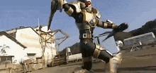 a man in a knight 's armor is holding a sword in front of a building