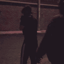 a person in a cat mask is standing next to another person
