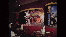 a looney tunes poster hangs above a restaurant