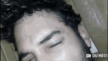 a close up of a man 's face with the words du rec on the bottom right corner