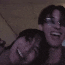 a man and a woman are making funny faces and one of them is wearing glasses