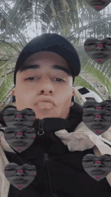 a man wearing a black hat and a black jacket is surrounded by hearts with faces on them