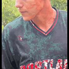 a close up of a man wearing a jersey with the word softball on it .