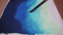 a brush is being used to paint a blue and white gradient