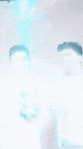 two men are standing next to each other holding a blue and pink confetti cannon