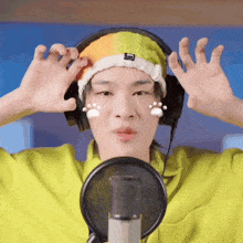 a person wearing headphones and a beanie with paw prints on it
