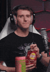 a man is holding a bag of lays ketchup