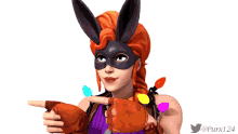 a woman wearing bunny ears and gloves points at something