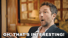a man in a suit says " oh that 's interesting " in front of him