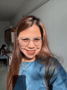 a woman wearing glasses is smiling for the camera