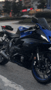 a blue and black yamaha motorcycle is parked on a street