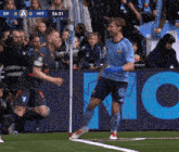 two soccer players on a field with a sign that says diff on it