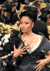 a woman in a striped suit has a yellow et logo on the bottom