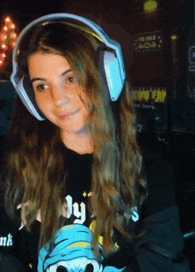 a girl wearing headphones and a black shirt that says simply