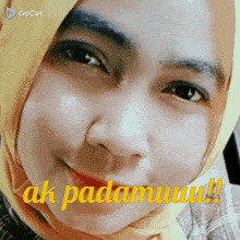a close up of a woman 's face with the words ak padamuu written on the bottom