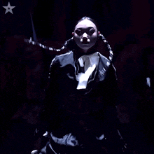 a woman in a black and white outfit with a white star in the background