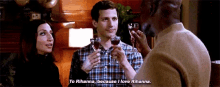 a man and a woman are toasting with wine glasses while a man says to rihanna , because i love rihanna