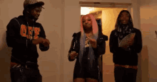 a group of young people are standing next to each other in a room .