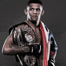 a man wearing a belt that says ufc holds an american flag