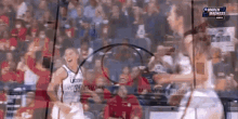 a blurred image of a basketball game with march madness on the bottom right