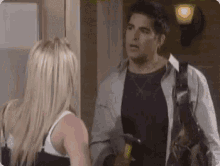 a man and a woman are talking to each other in a room .
