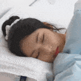 a woman is sleeping on a bed with a pillow that says cool & glow