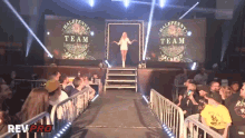 a woman is walking down a ramp that says halfpenny team jackson on it