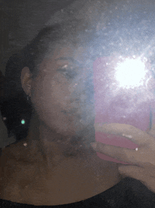a woman is taking a picture of herself with her phone