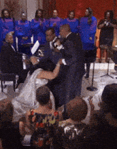 a bride and groom are getting married in front of a group of people