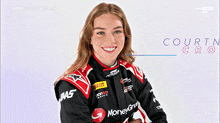 a woman in a racing suit with moneygram on the sleeves