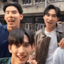 a group of young men are posing for a picture and smiling .