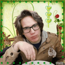 a picture of a man with glasses and a plate of food has a picture of a rabbit on the bottom right corner