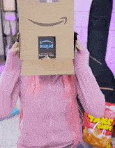 a woman covering her face with a cardboard box that says prime