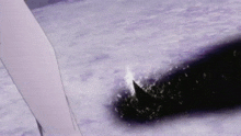 a person is holding a sword in the snow .