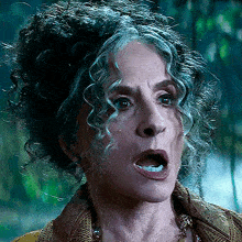 a close up of a woman 's face with curly hair