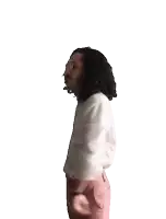 a person in a white shirt and pink pants is raising their arm in the air