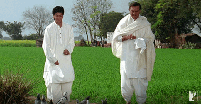 two men in white standing in a field with a logo that says ' a ' on it