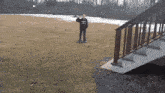 a man wearing a black sweatshirt that says ' aquinas ' on it