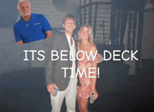 a man in a blue shirt stands next to a woman in a pink dress with the words its below deck time
