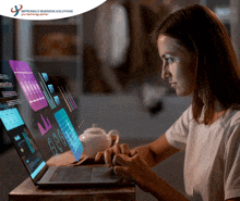 a woman is typing on a laptop in front of an advertisement for impressco business solutions