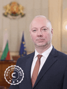 a man in a suit and tie stands in front of flags and a www.cutout.pro seal