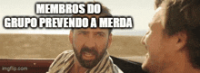 a man with a beard is talking to another man with the words members do grupo prevento a merda written above him