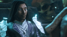 a woman with long black hair and blue eyes is wearing a purple jacket