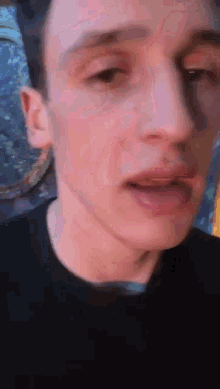 a close up of a man 's face with his mouth open and his eyes closed