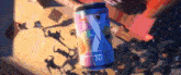 a can of soda is sitting on a table in front of a crowd of people .