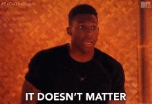 a man says it does n't matter in front of a wooden wall