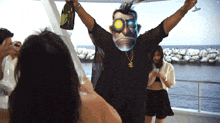 a man is holding a bottle of champagne and a mask with the letter a on it