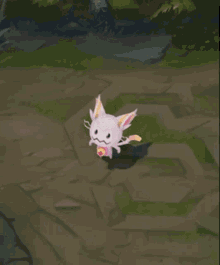 a pink and white cat with a yellow head and tail is standing on a rocky ground .