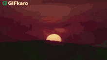 a sunset with a large sun in the middle of the sky .